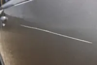 Close-up of a scratch on the front right door